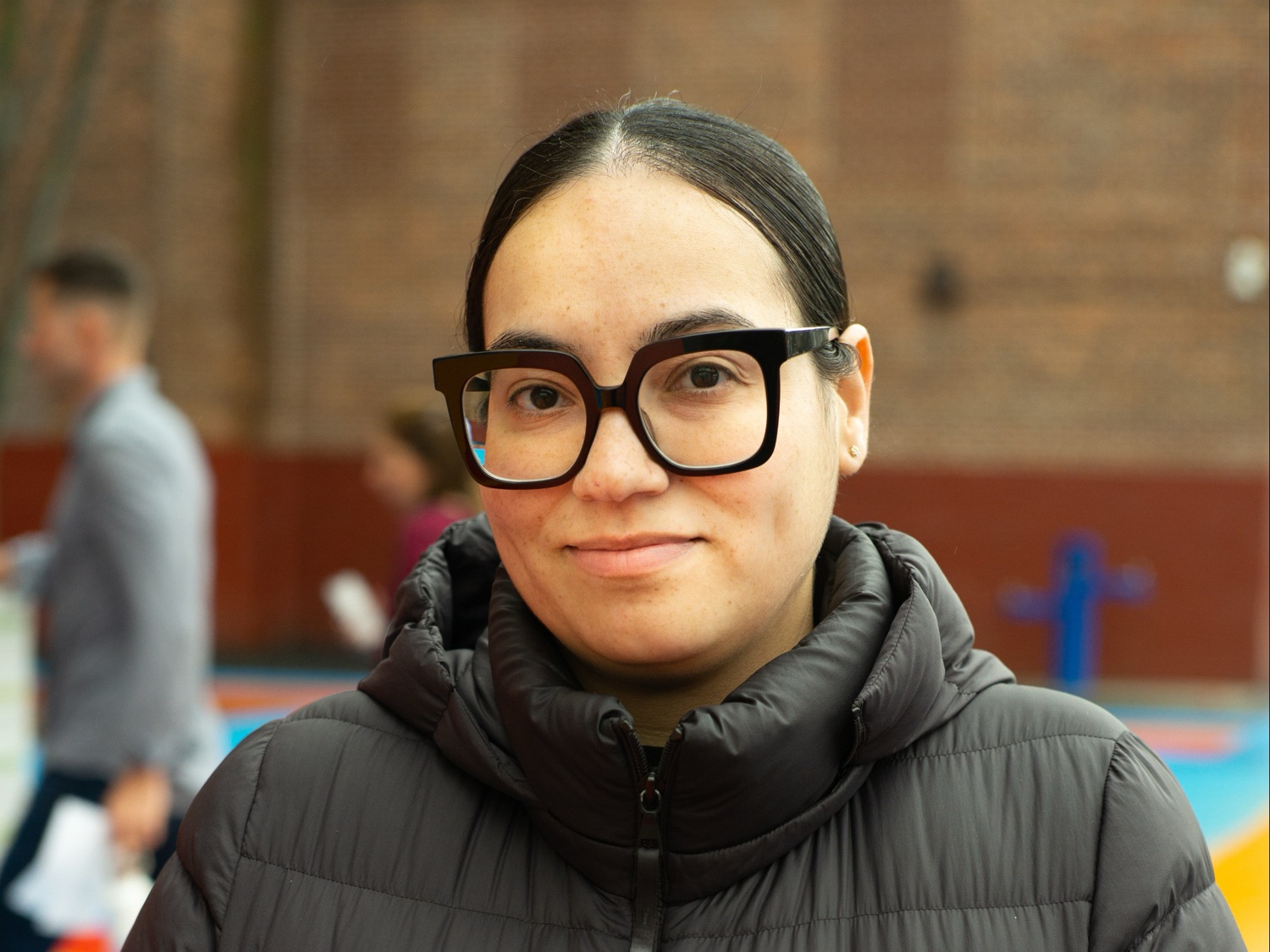A program staff member smiling outside on the playground