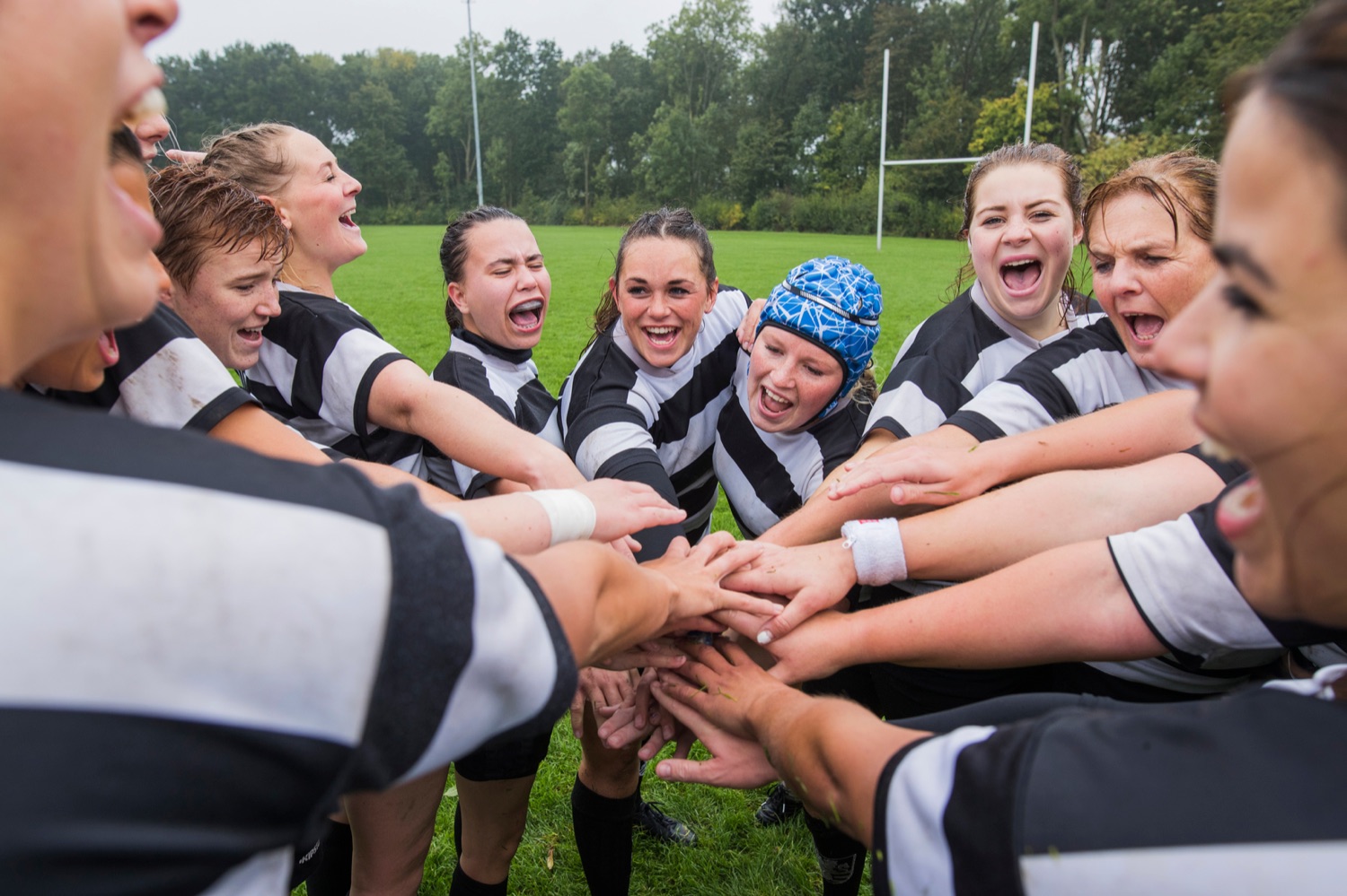 A youth team stacking hands in a huddle