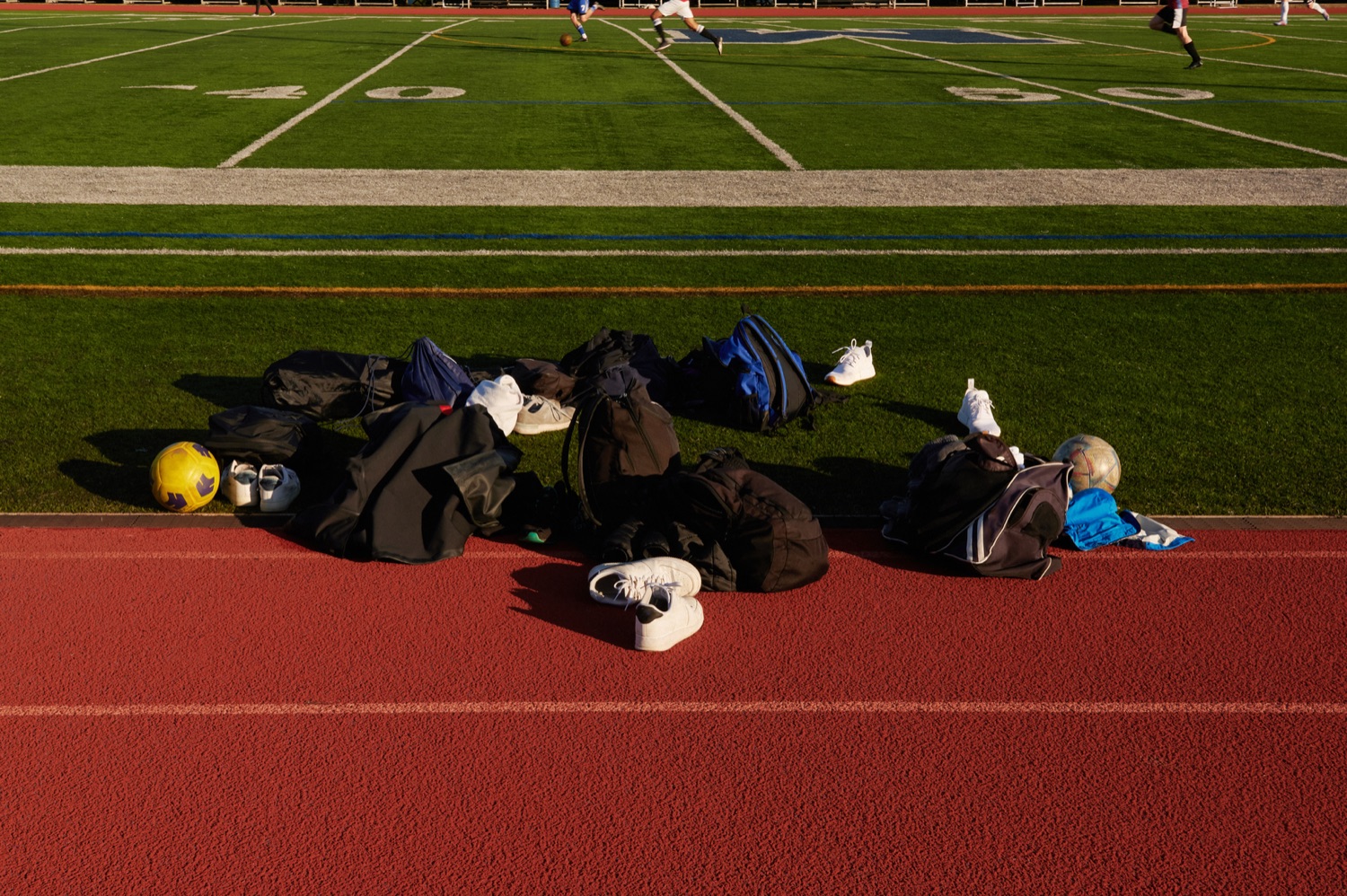 Team bags and gear lined up beside the track