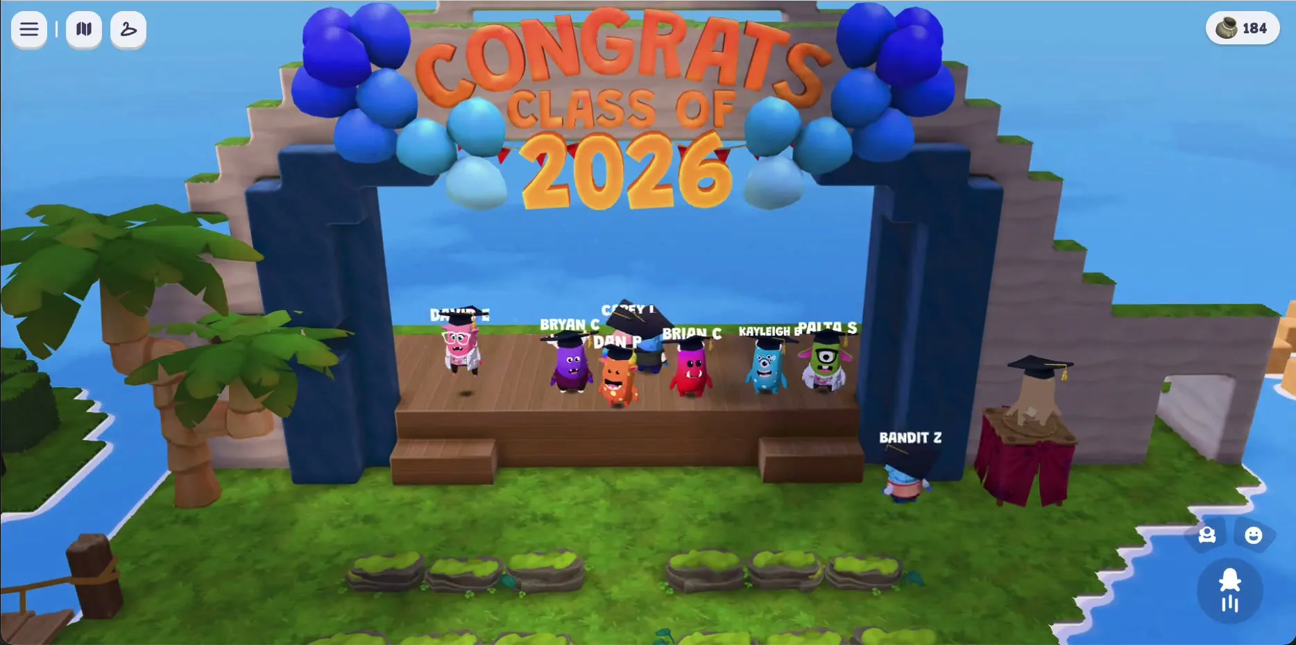 The graduation stage on Dojo Islands. Seven characters in graduation caps lined up across a wooden stage under a CONGRATS CLASS OF 2026 balloon archway.