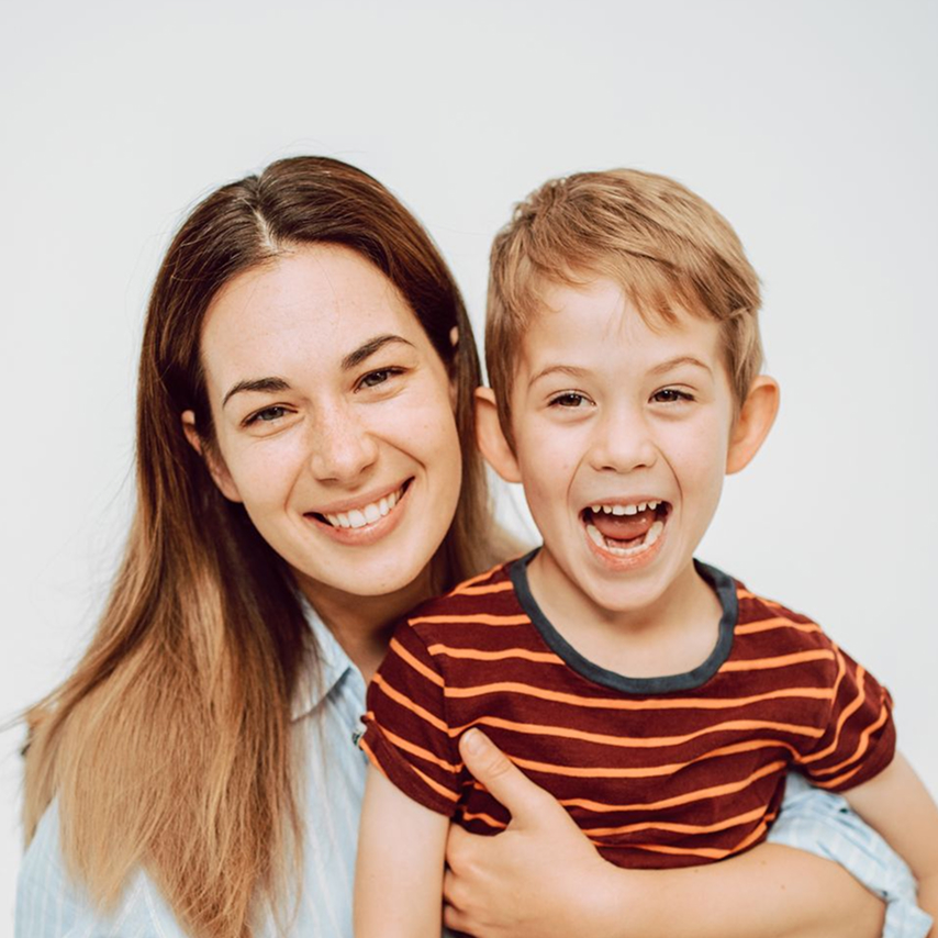 A smiling mother holding her son